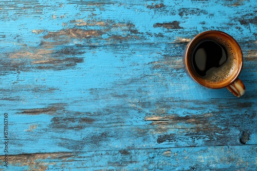 Coffee cup filled with coffee on a blue distressed wooden table