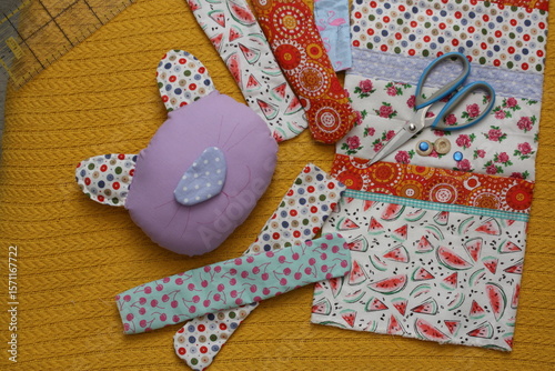 Textile cat made of bright stripes of beautiful cotton fabrics. Concept - handmade, sewing a toy with your own hands.