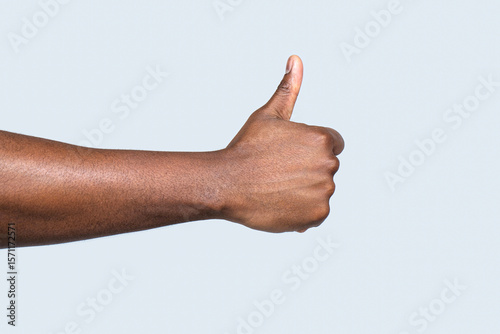 Like gesture. Closeup hand showing thumbs up. Man hands showing thumbs up. Support encourage. African male hand showing thumb up. African american hands showing like