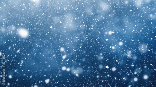 Falling Snowflakes in a Winter Storm, Blue Background, Atmospheric Winter Scene.