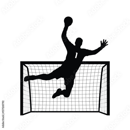 Silhouette of a handball goalkeeper making a save in front of the net