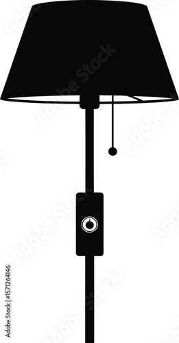 A sleek floor lamp with a classic shade stands tall, ready to illuminate any room with its warm and inviting glow