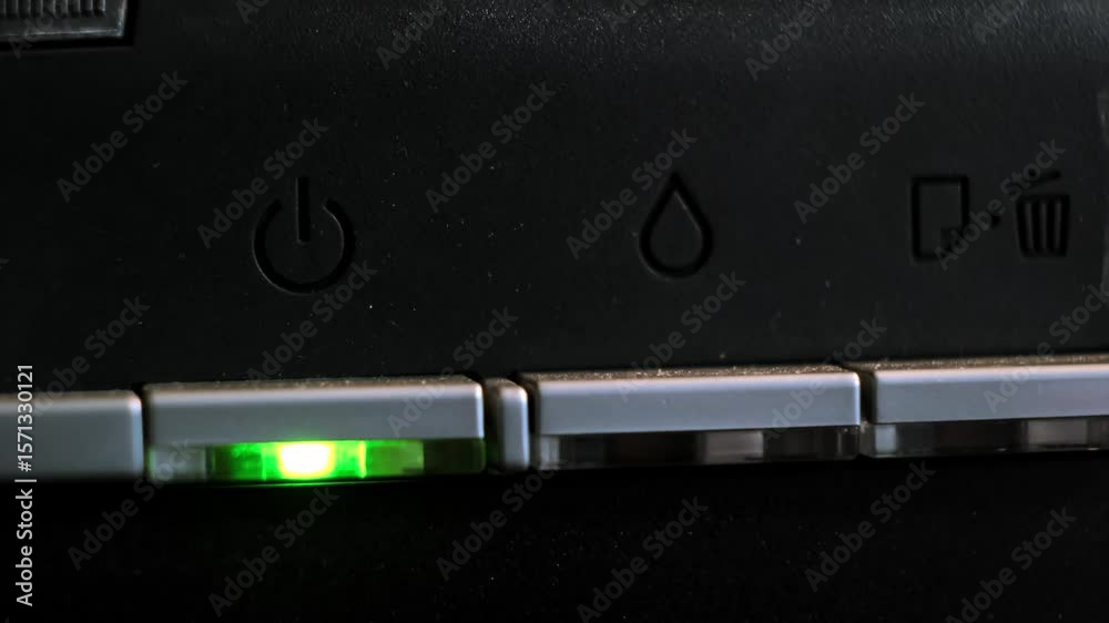 The green light on the printer is on and the red light is flashing, indicating a malfunction of the device or the need to refill it with ink. The need for office equipment maintenance. 4k footage.