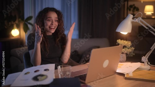 A woman goes through various emotions while working late on her laptop in a cozy home office setting