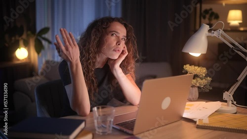 A young successful girl thinks about solving a problem by working remotely from home