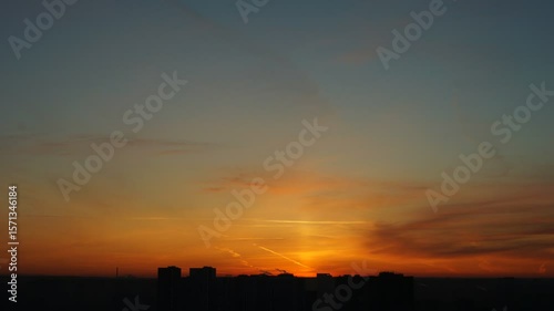 Dawn clouds over the metropolis of early winter sunset