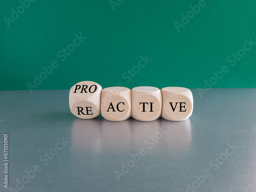 Reactive or proactive symbol. Turned a cube and change the word reactive to proactive. Beautiful green background, Business and reactive or proactive concept