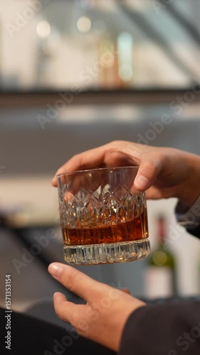 Closeup business woman holding a glass of whiskey