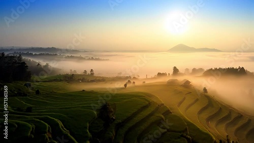 Scenic sunrise over lush green terraced landscape with misty mountains and valley views, capturing peaceful rural morning scene with vibrant natural beauty