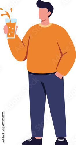 Young man holding glass with beverage splash wearing orange sweater and blue pants standing isolated