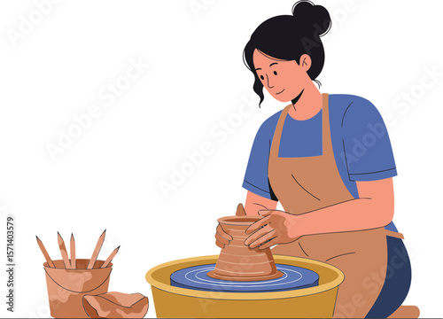 Woman shaping clay pottery on potter wheel in creative workshop with blue shirt and apron