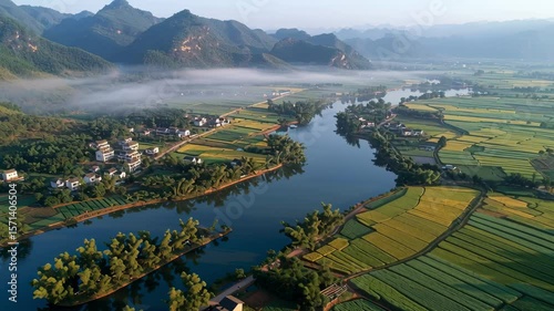 Aerial Drone Shot of Serene Karst Landscape with River and Rural Villages in Morning Mist