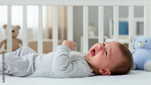A newborn baby in onesie is crying with tears in a white crib. Concept of infant colic, discomfort, or need for attention. Use for parenting blogs, childcare resources, and pediatric services