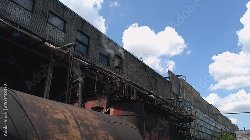 Industrial Steam Vents Against Cloudy Sky