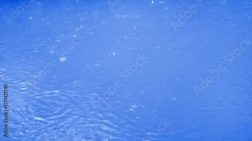  rain Drop Circle Ripples on blue Water Surface  Slow Motion Stock 4k Video footage.