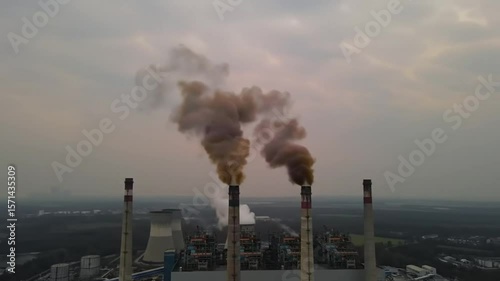 Aerial cinematic video illustrating atmospheric pollution due to emissions from a power plant. The generation of electricity from diesel results in air pollution with gas emissions. High-quality 4K