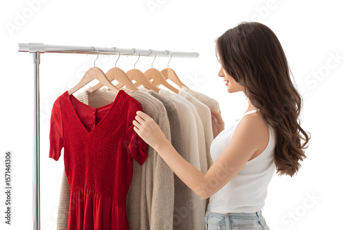 Young woman selects clothing from a rack.