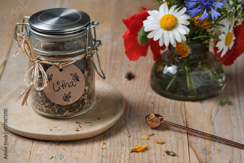 Fotografia Litha incense blend with herbs and resins on rustic wooden table
