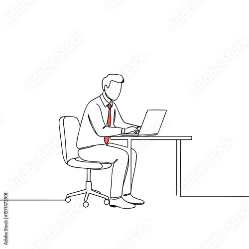 Businessman working on laptop while sitting at desk in office  