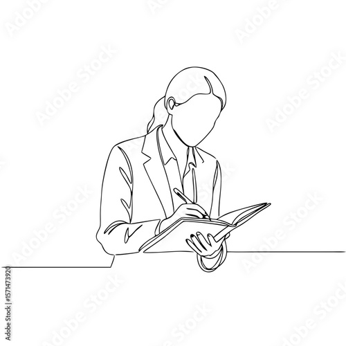 Businesswoman writing notes in a notebook while sitting at a table  