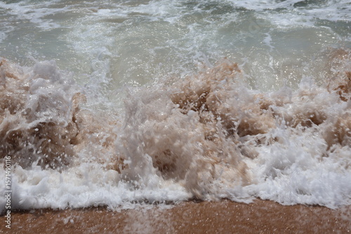 Fototapeta Naklejka Na Ścianę i Meble -  Turbulent Ocean Wave Crashing on Sandy Beach