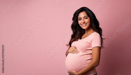 Beautiful Young Indian Pregnant Woman in Stylish T-Shirt on Pink Background