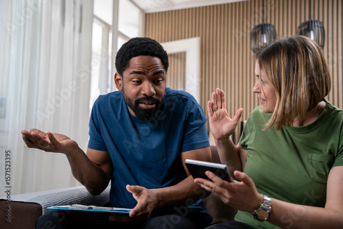 Bild auf Leinwand Mixed race couple stressed about household finances, rising food and housing cos