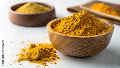 Colorful spices and herbs like turmeric, paprika, and chili powder are isolated in white bowls, perfect ingredients for spicy curry and seasoning your food