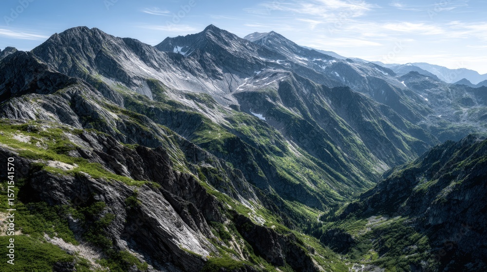 A scenic view of a mountain valley with rugged peaks and lush vegetation. A scenic view of a mountain valley with rugged peaks and lush vegetation.