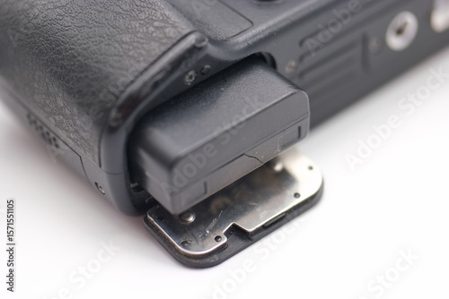 Close up view of a camera battery compartment showing detailed components and structure