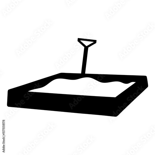 Silhouette of a sandbox with sand and a shovel in black and white