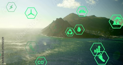 Following aerial view, icons fading and drifting over mountain island showing sustainable energy