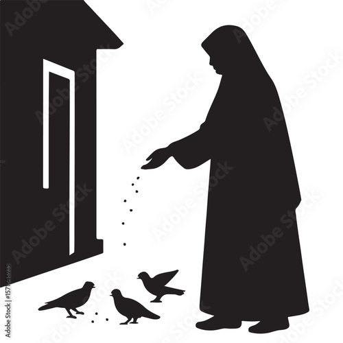 Silhouette of a person in a long robe feeding pigeons seeds near a building