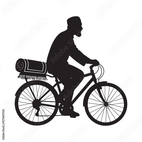 Silhouette of a muslim man riding a bicycle with a prayer mat on the back