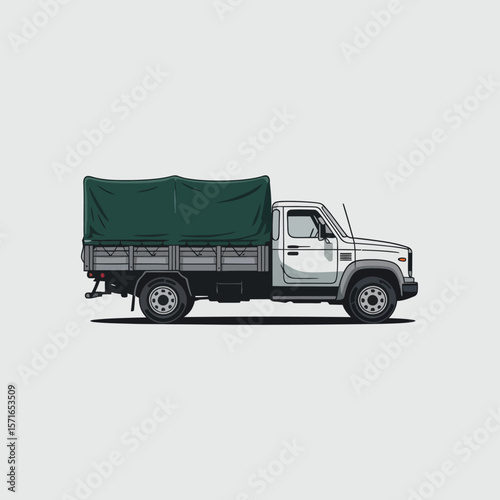 Flatbed truck with a green tarp covering the cargo bed