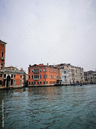 Beautiful waterfront buildings along a canal in Venice under a cloudy sky during the day
