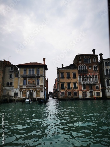 Charming canals of Venice with historic buildings lining the waterway on a cloudy day in autumn