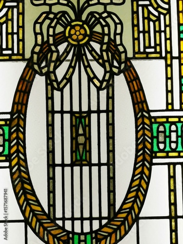 Beautiful stained glass design showcasing an elegant oval frame and intricate patterns in vibrant colors