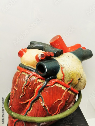 Colorful heart sculpture featuring elements of industrial design positioned on a wooden surface