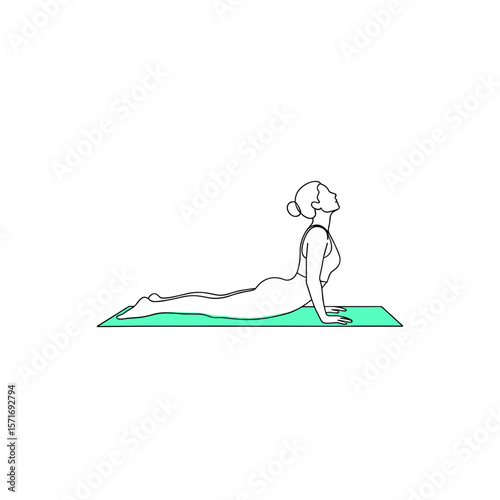 Woman practicing cobra pose in yoga on green mat  