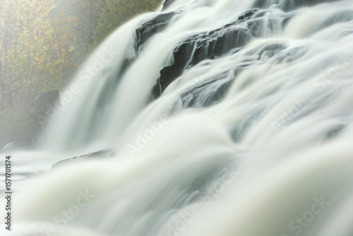 Autumn landscape of Bond Falls in fog captured with motion blur, Michigan's Upper Peninsula, USA