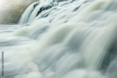Autumn landscape of Bond Falls in fog captured with motion blur, Michigan's Upper Peninsula, USA