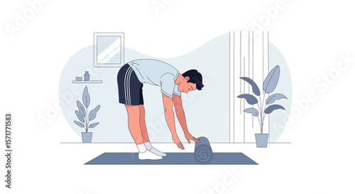 Young Man Rolling up His Yoga Mat After Home Workout Routine