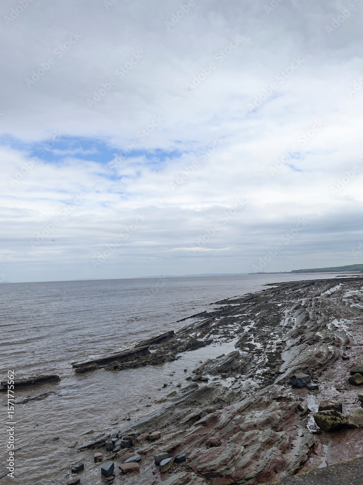 Fototapeta premium Watchet, UK, March 15, 2025. Watchet beach, coastal village, Somerset coast, England