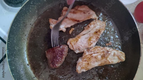 Cooking Chicken and Meatballs in a Pan Footage.