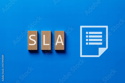 There is wood block with the word SLA. It is an abbreviation for Service Level Agreement as eye-catching image.