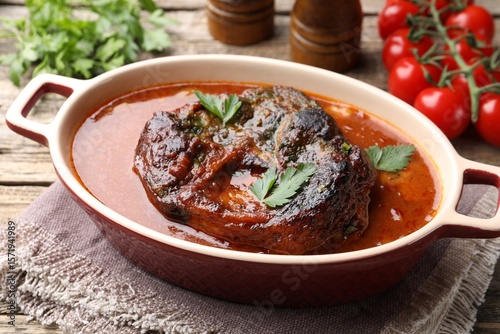 Canvastavla Traditional ossobuco dish with beef steak and sauce served on table, closeup