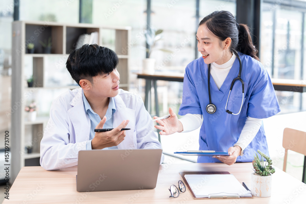 Happy Doctor and nurse discussing medical report at clinic Happy Doctor and nurse discussing medical report at clinic