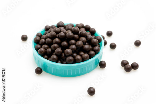 Chinese Herbal Medicine Pills Spilled from Brown Glass Bottle on White Isolated Background – Traditional Asian Medicinal Pills