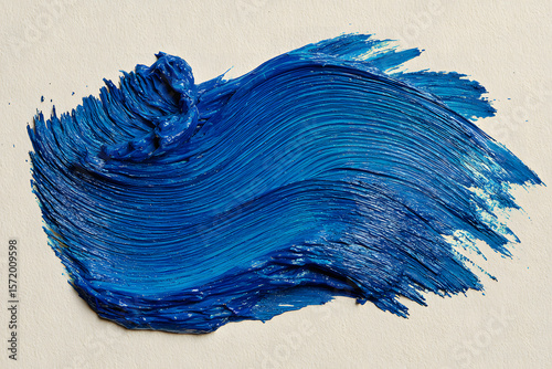 Single abstract acrylic paint stroke, vivid ultramarine blue with visible bristle texture and irregular edges, medium opacity with subtle paint thickness variations, dynamic brush shape, isolated on a